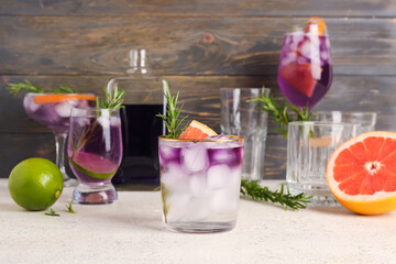 Purple gin and tonic with ice on table