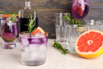 Purple gin and tonic with ice on table