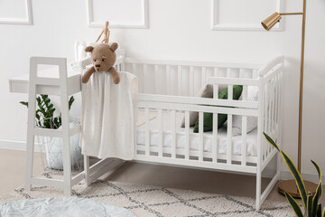 Interior of light bedroom with baby crib and changing table - obrazy, fototapety, plakaty