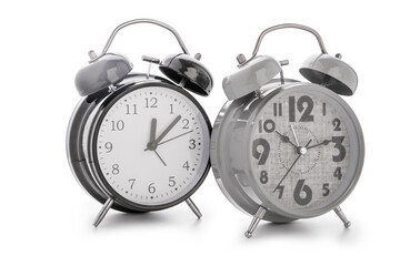Metal alarm clocks on white background