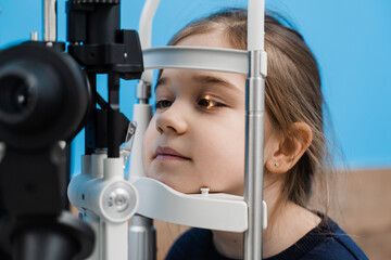 Pediatric ophthalmologist with slit lamp examines eyes and cornea of child. Ophthalmologist...