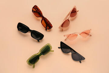 Stylish sunglasses on beige background