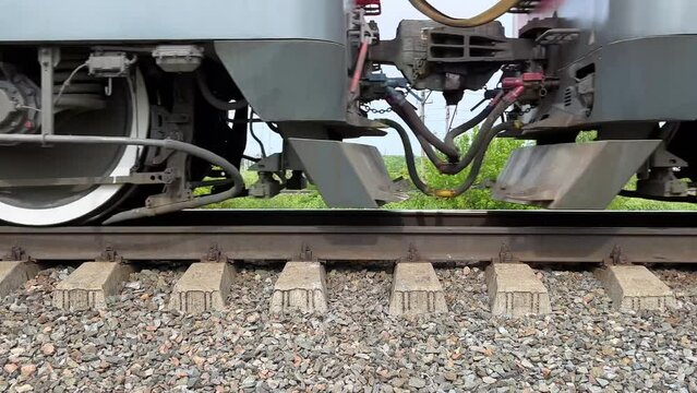 Freight train is passing by. Moving wheels of a cargo train, close-up. Railway. Static video