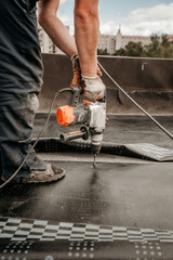 roof repair. a roofer repairs the roof. roofing tools