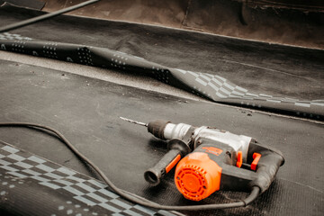 roof repair. a roofer repairs the roof. roofing tools