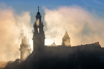 Krakow, Poland, Wawel cathedral towers shrouded in the fog, sunlit in the morning - 608807578