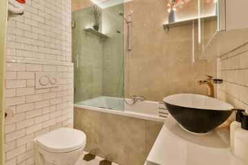 a bathroom with a sink, toilet and bathtub on the floor in front of the shower stall is white