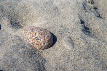Fototapeta na wymiar Rocks on the seashore. The sandy shore of the sea. Waves on the Baltic Sea.