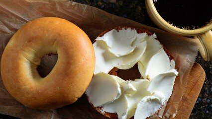 Savory Delights: Close-Up of Cream Cheese-Spread Bagel on a Delectable Food Background in Stunning 4K