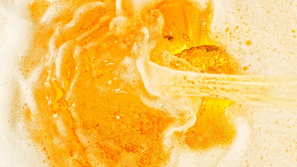 Detail of pouring beer beverage, abstract fresh drink background