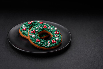 Delicious Christmas gingerbread cookies on a dark textured concrete background