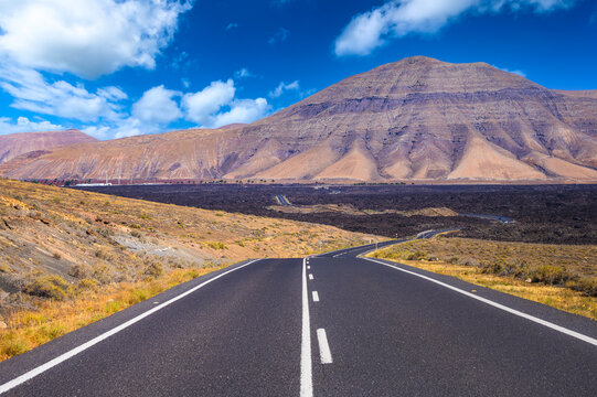 Endless road through the lava fields of Lanzarote, Canary Island, Spain