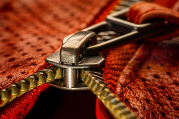 Macro photo of zipper on red leather jacket
