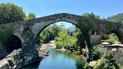 Fototapeta na wymiar Old Roman stone bridge in Cangas de Onis. Cangas de Onis roman bridge on Sella river in Asturias of Spain