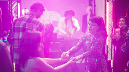 People dancing in pairs on slow music, enjoying romantic waltz on dance floor. Happy couples...