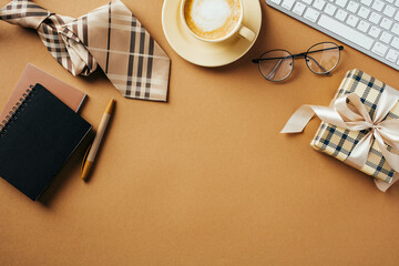Happy Fathers Day flat lay composition with coffee cup, keyboard, glasses, paper notebooks, vintage gift box on brown table