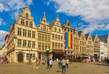 Market Square of Belgian city of Antwerp with big Pride flag on facade of one of ancient buildings...