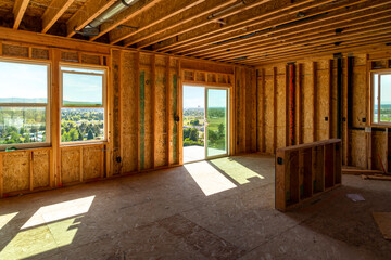 A framed new construction home being built on a hilltop overlooking the cities of Spokane and...