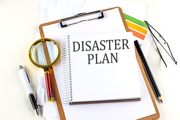 DISASTER PLAN text on notebook with clipboard on white background