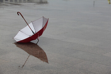 red and white umbrella in rainy time - obrazy, fototapety, plakaty