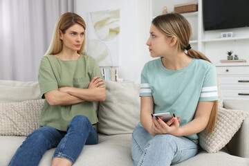 Mother angry at her daughter in living room