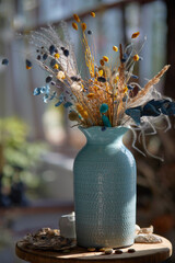 Still-life. Pampas dried grass and flowers in a vase. Cozy, stylish autumn concept.