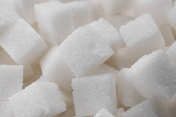 White sugar cubes as background, closeup view
