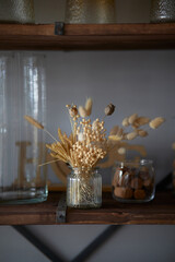 Still-life. Pampas dried grass and flowers in a vase. Cozy, stylish autumn concept.