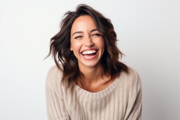Fototapeta premium Close up portrait of a laughing young woman isolated on a white background