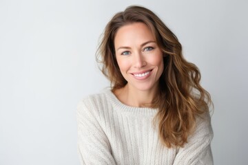 Fototapeta premium Portrait of a beautiful woman smiling at the camera over white background
