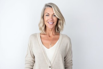 Obraz premium Portrait of beautiful mature woman smiling at camera while standing against white background