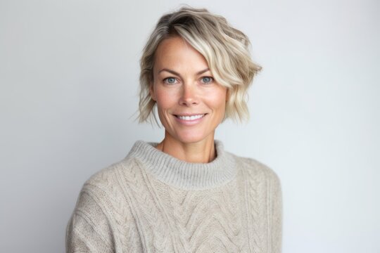 Group portrait photography of a tender woman in her 40s that is wearing a cozy sweater against a white background . Generative AI
