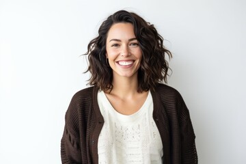 Portrait of beautiful young woman smiling at camera against a white background