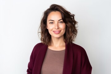 Obraz premium Portrait of a beautiful young woman smiling at the camera on a white background