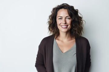 Lifestyle portrait photography of a satisfied woman in her 30s that is wearing a chic cardigan against a white background . Generative AI - obrazy, fototapety, plakaty