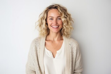 Fototapeta premium Portrait of a smiling young woman looking at camera over white background