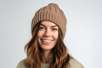 Close up portrait of a smiling young woman wearing a knitted hat