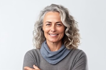 Fototapeta premium Portrait of a happy mature woman smiling at camera isolated on a white background