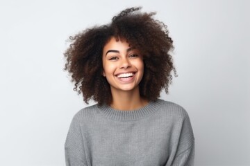 Fototapeta premium Portrait of a beautiful young african american woman laughing over white background