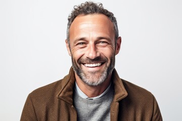 Portrait of a handsome middle-aged man smiling against a white background