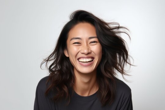 Portrait of a happy young asian woman smiling on white background