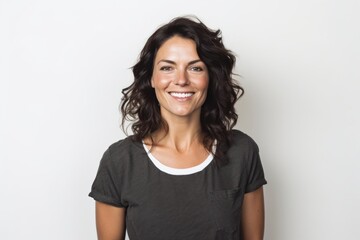 Fototapeta premium Portrait of smiling woman in grey t-shirt against white background
