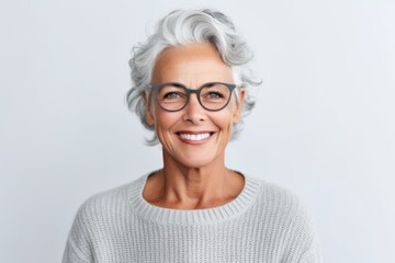 Portrait of a smiling senior woman wearing eyeglasses isolated over white background