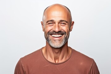 Portrait of a happy mature man smiling and looking at the camera on a white background
