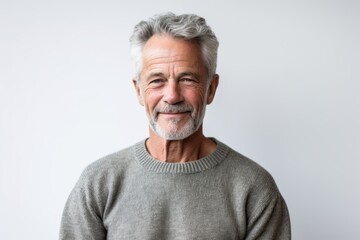 Obraz premium Portrait of happy senior man with grey hair standing against white background