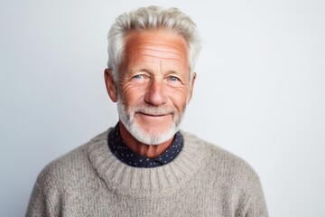 Portrait of happy senior man looking at camera over white background.