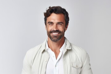 Fototapeta premium Portrait of a handsome man smiling at the camera over white background