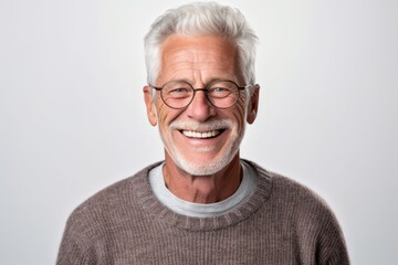 Portrait of a smiling senior man with eyeglasses on white background