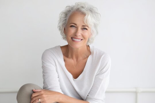 Portrait of a smiling senior woman sitting on the floor at home