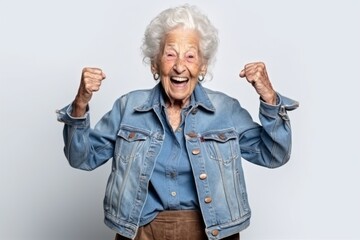 Medium shot portrait photography of a satisfied 100-year-old elderly woman that is wearing a denim jacket against a white background . Generative AI